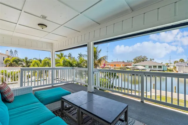 a kitchen with stainless steel appliances granite countertop a dining table chairs stove refrigerator and cabinets