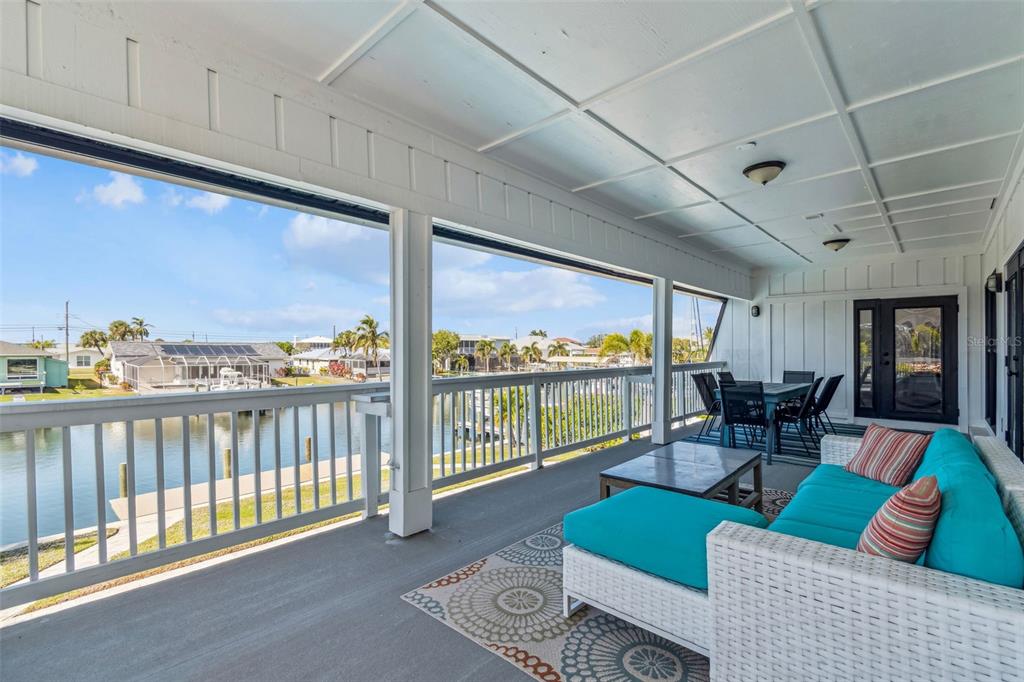 4907 Beacon Road Palmetto, FL 34221 - Photo 12 of 80 a living room with furniture and a floor to ceiling window