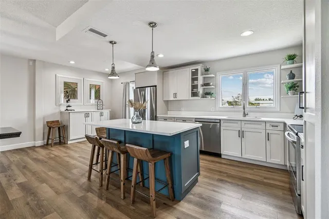 a bedroom with two beds and a chandelier