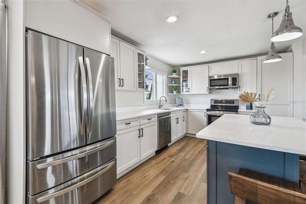 4907 Beacon Road Palmetto, FL 34221 - Photo 22 of 80 a kitchen with refrigerator cabinets and a sink