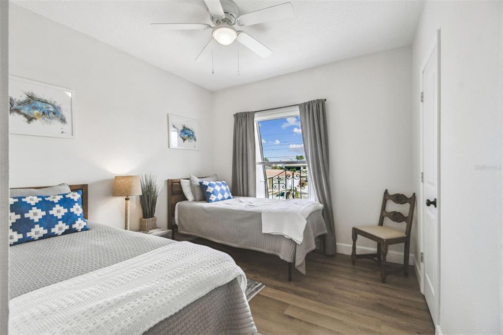 4907 Beacon Road Palmetto, FL 34221 - Photo 33 of 80 a bedroom with two beds and a chandelier