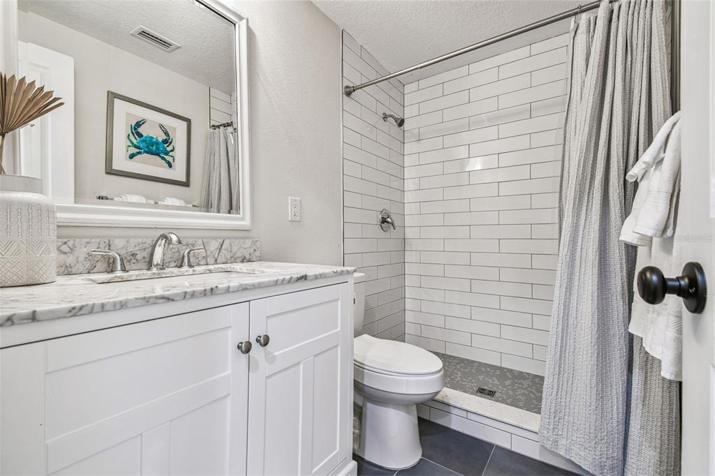 4907 Beacon Road Palmetto, FL 34221 - Photo 36 of 80 a bathroom with a granite countertop sink toilet and shower