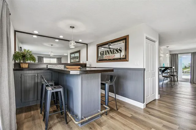 a view of a house with a yard and a table under an umbrella