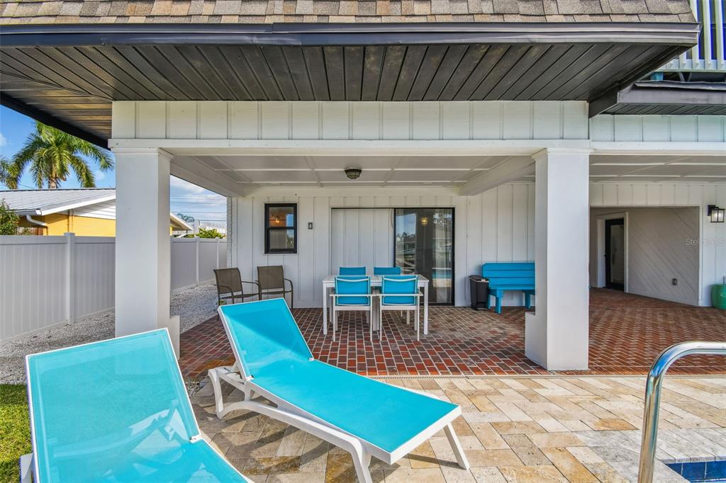 4907 Beacon Road Palmetto, FL 34221 - Photo 53 of 80 a view of a patio with table and chairs with wooden floor and fence