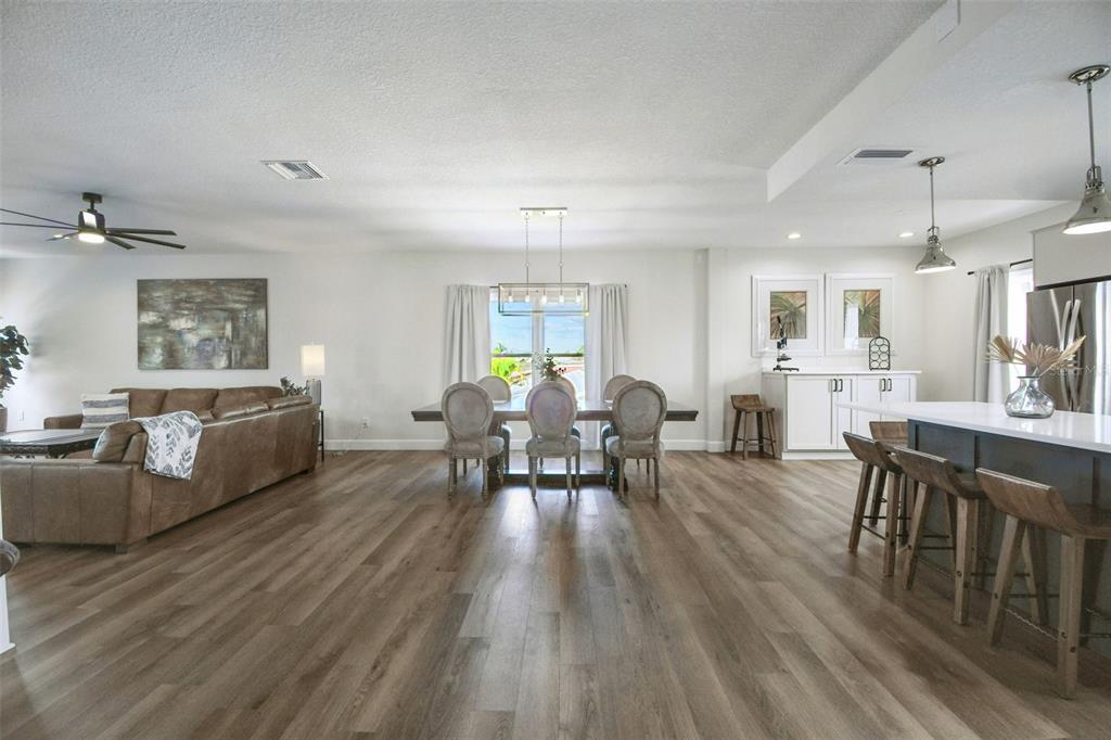 4907 Beacon Road Palmetto, FL 34221 - Photo 6 of 80 a living room with furniture dining table and a wooden floor