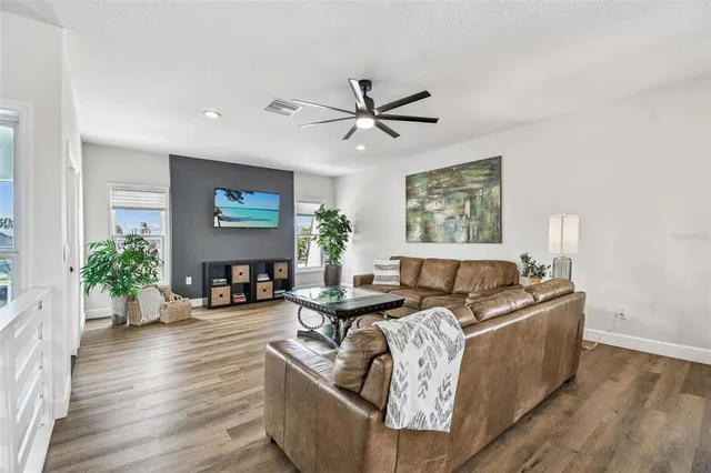 a living room with furniture and a floor to ceiling window