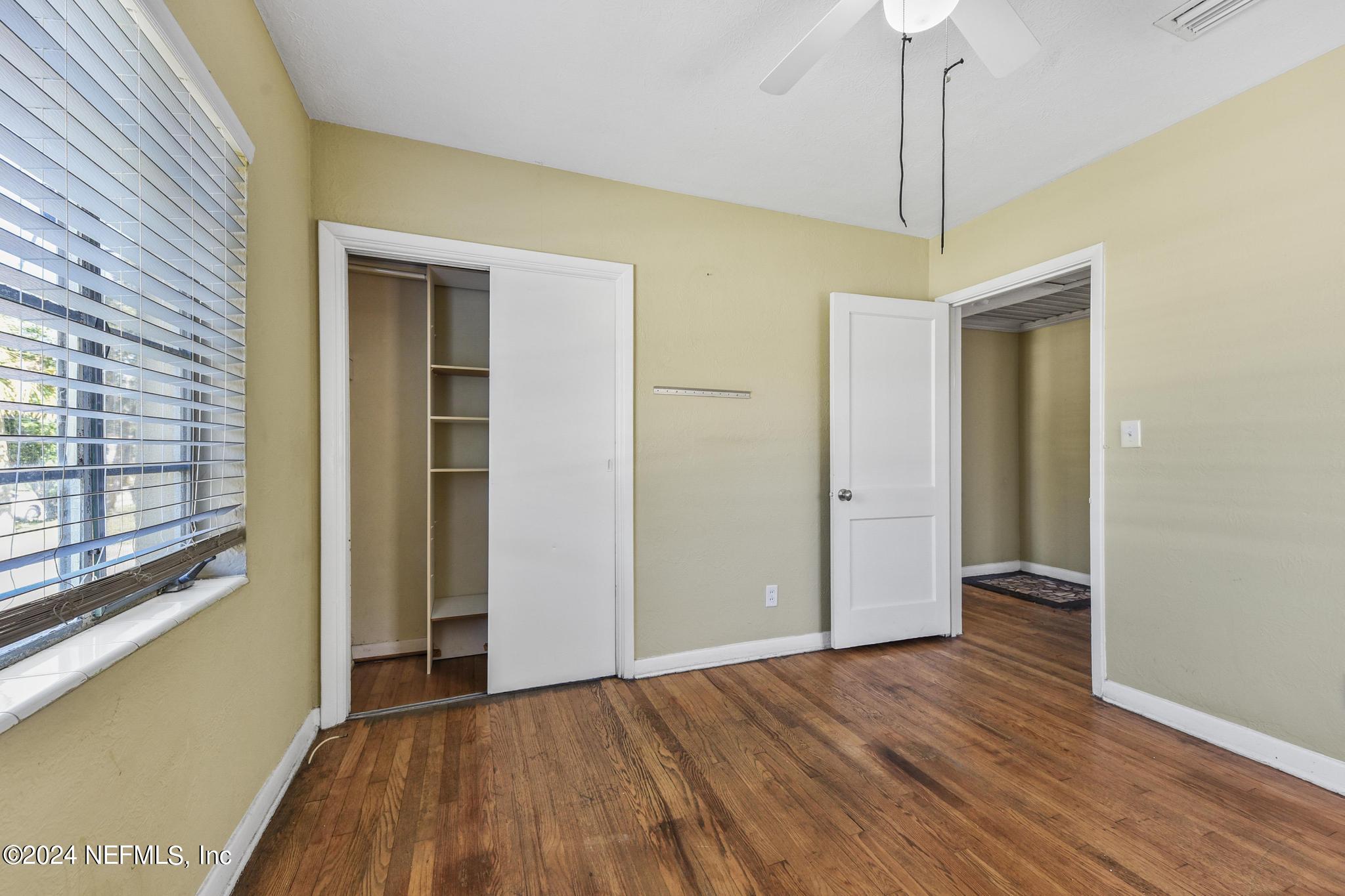 6029 Duke Road Jacksonville, FL 32217 - Photo 17 of 23 a view of an empty room with wooden floor and a window