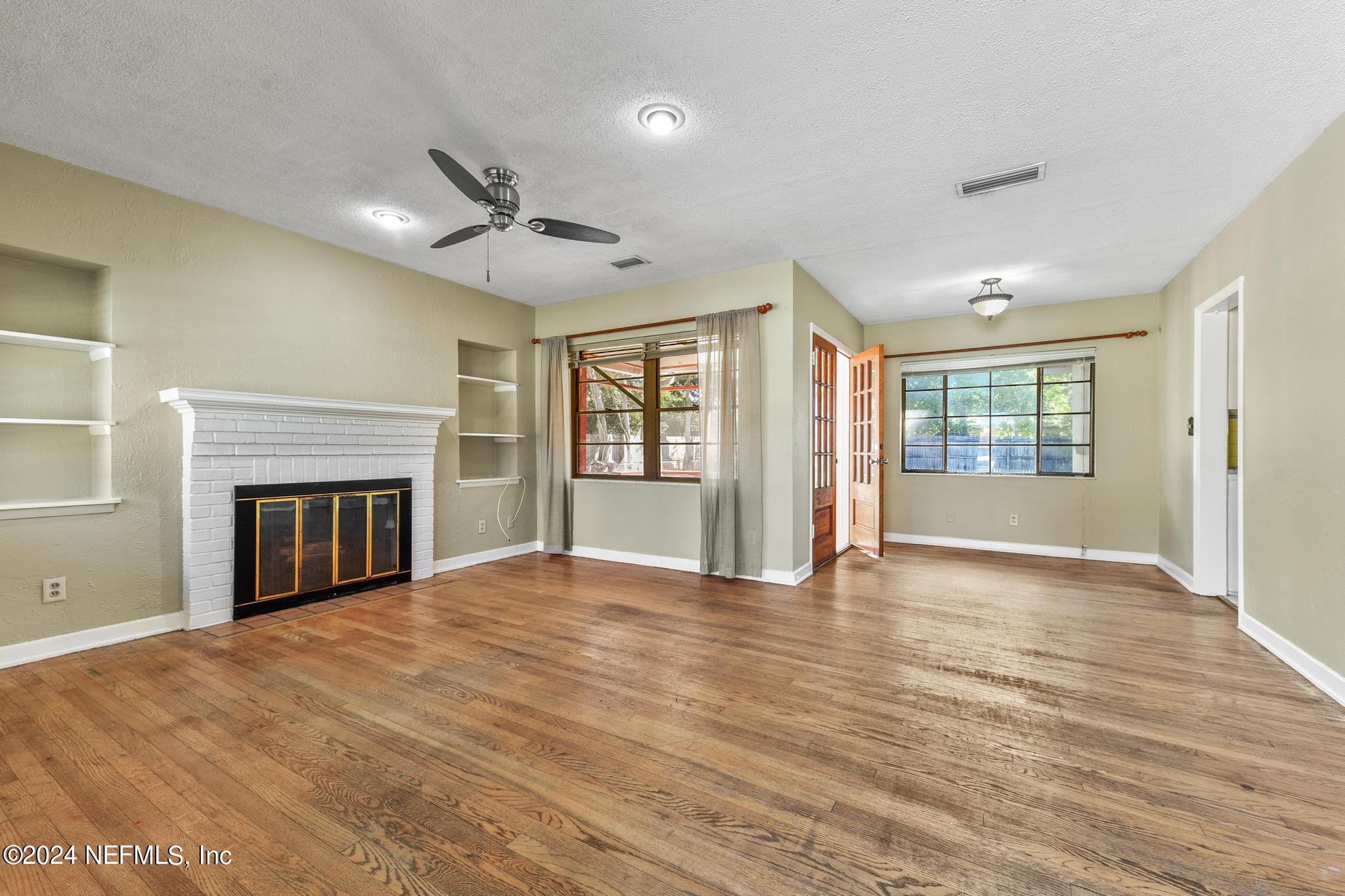 6029 Duke Road Jacksonville, FL 32217 - Photo 6 of 23 a view of an empty room with a window and fireplace