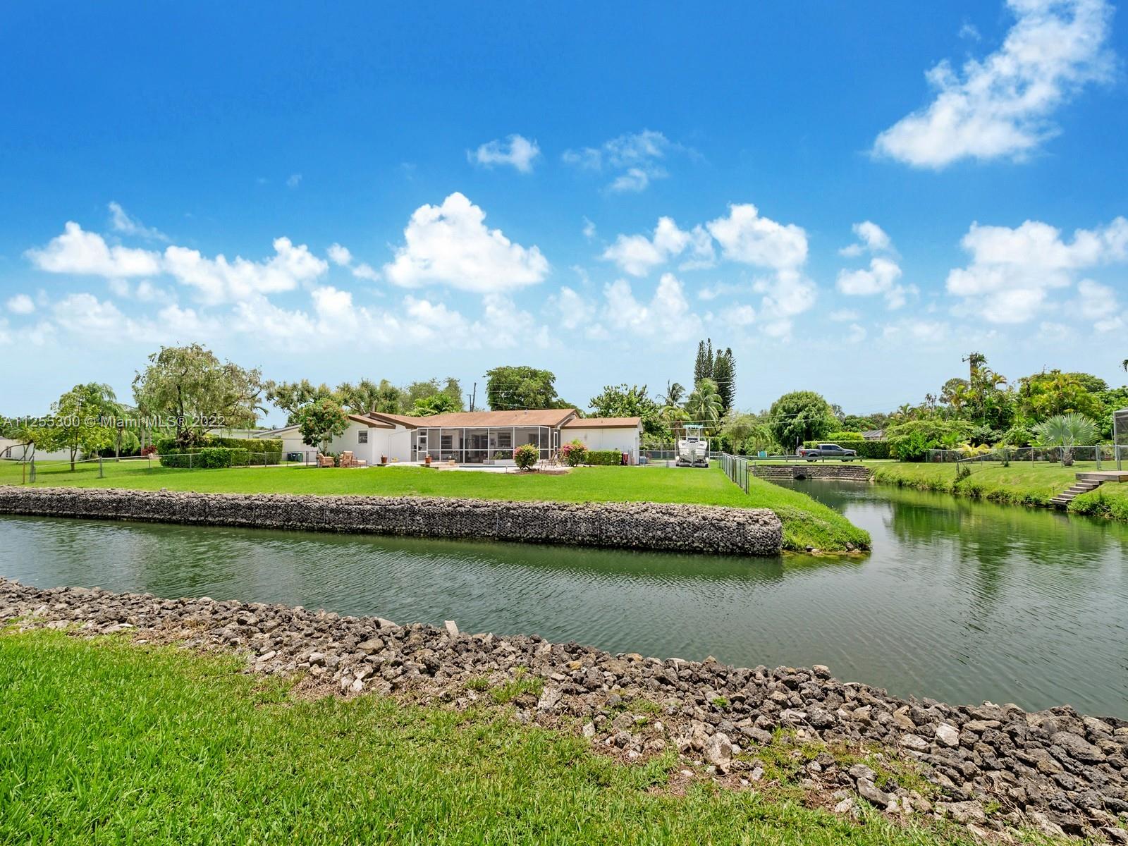 7001 Southwest 126th Street Pinecrest, FL 33156 - Photo 1 of 19 an aerial view of a house with a lake view