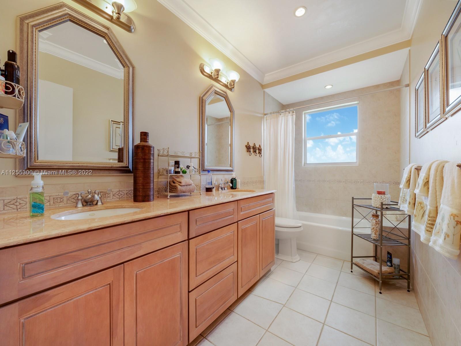 7001 Southwest 126th Street Pinecrest, FL 33156 - Photo 11 of 19 a spacious bathroom with a double vanity sink mirror and