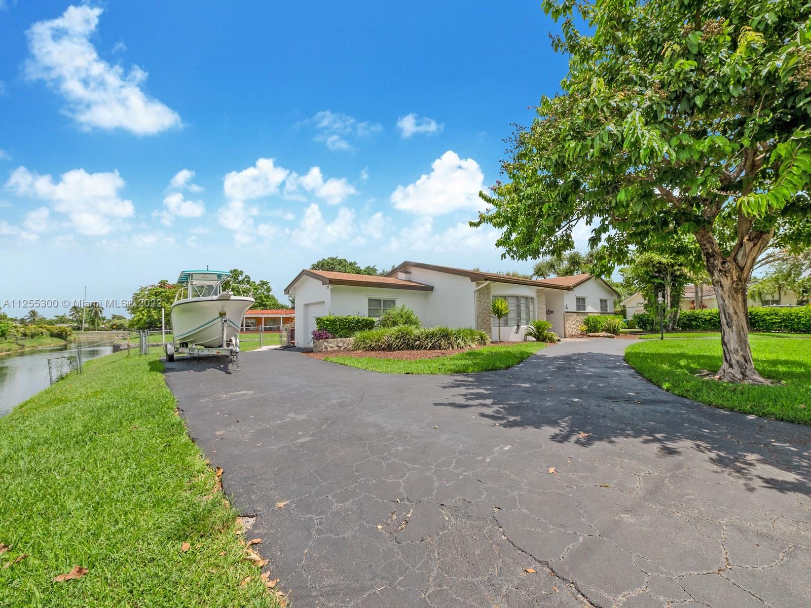 7001 Southwest 126th Street Pinecrest, FL 33156 - Photo 19 of 19 a front view of a house with garden