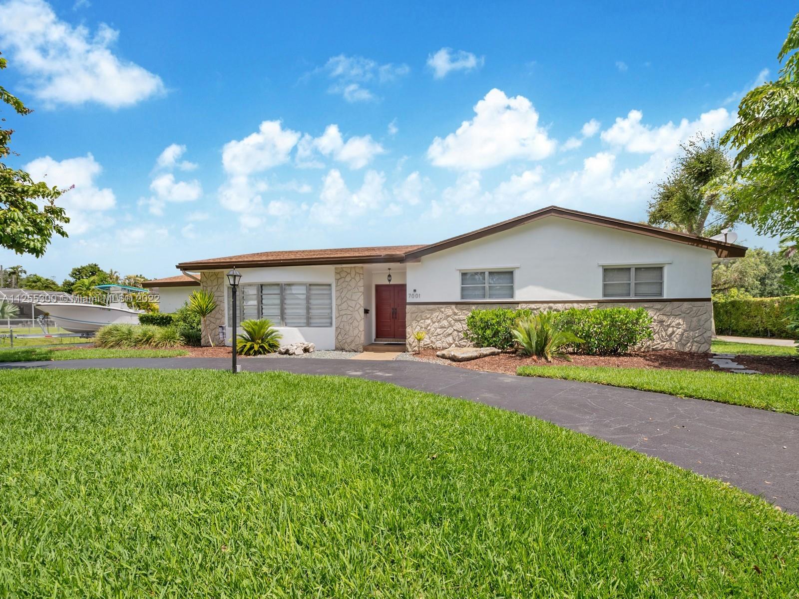 7001 Southwest 126th Street Pinecrest, FL 33156 - Photo 2 of 19 a front view of house with yard and outdoor seating
