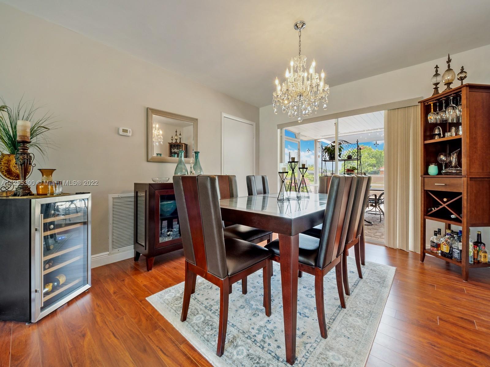 7001 Southwest 126th Street Pinecrest, FL 33156 - Photo 5 of 19 a view of a dining room with furniture window and wooden floor