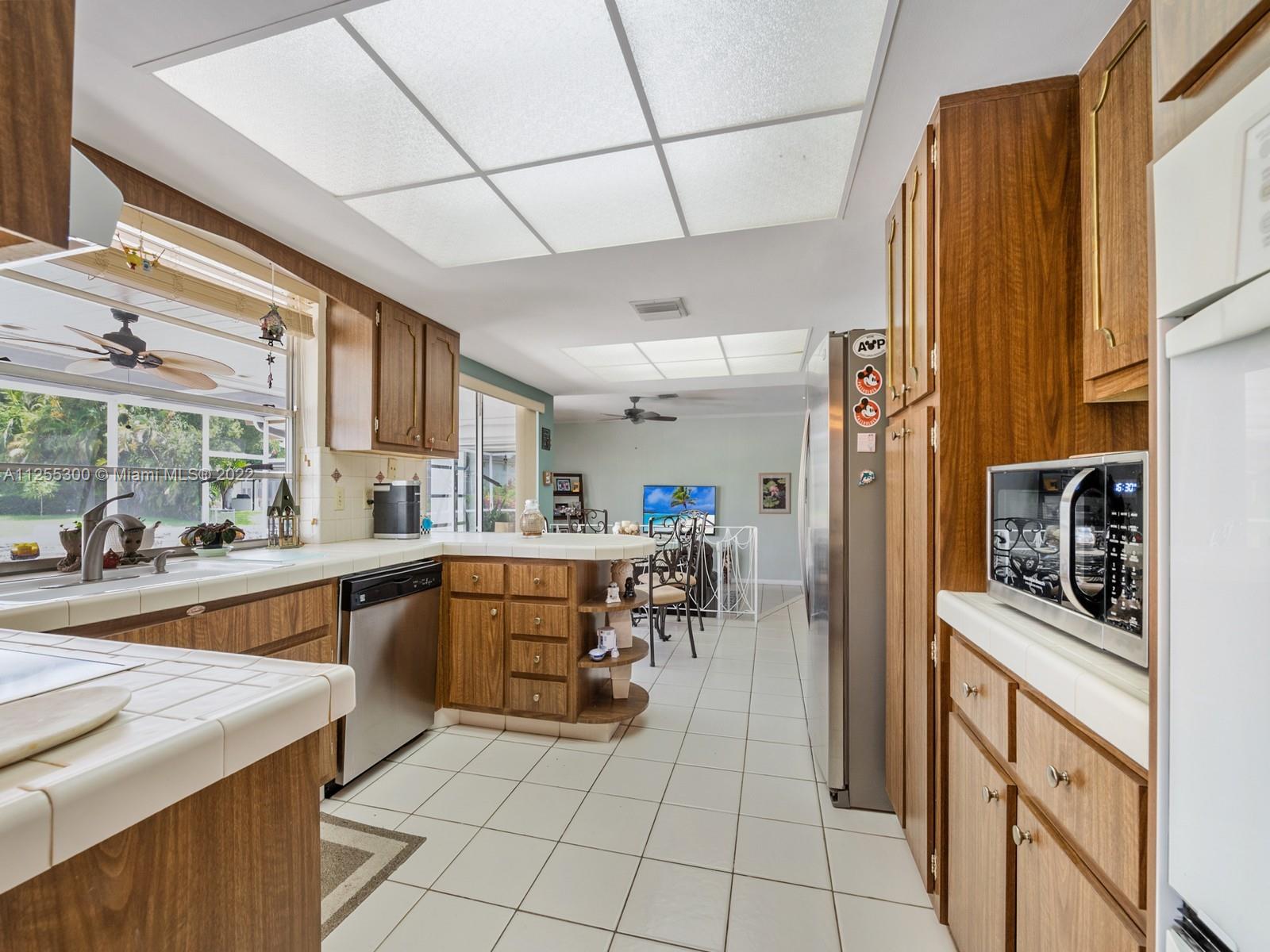 7001 Southwest 126th Street Pinecrest, FL 33156 - Photo 6 of 19 a kitchen with stainless steel appliances granite countertop a refrigerator and a sink