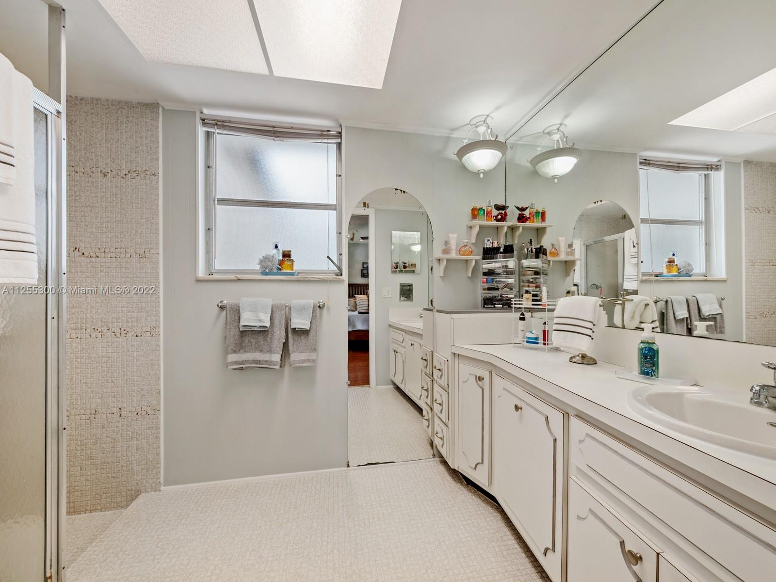 7001 Southwest 126th Street Pinecrest, FL 33156 - Photo 9 of 19 a large white kitchen with kitchen island a sink stainless steel appliances and cabinets