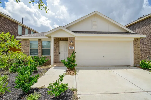 a view of a house with potted plants