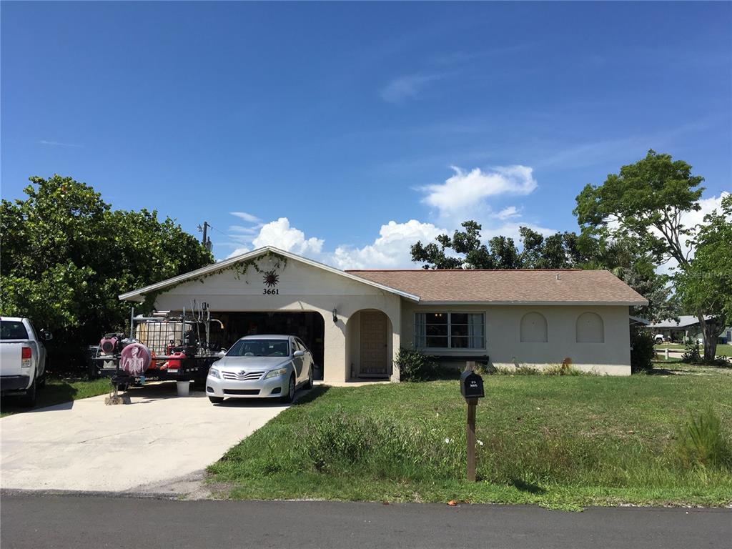 3661 Sterling Road Venice, FL 34293 - Photo 1 of 1 a front view of a house with a garden and mountain