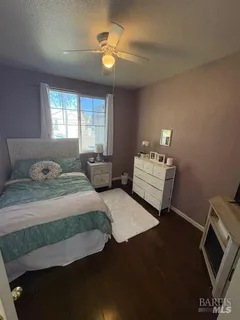 a utility room with a washer dryer and white cabinets