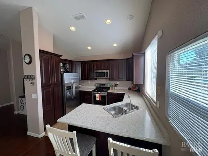 a large kitchen with a table and chairs