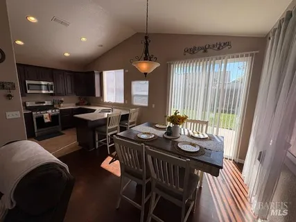 a view of a dining room with furniture window and outside view