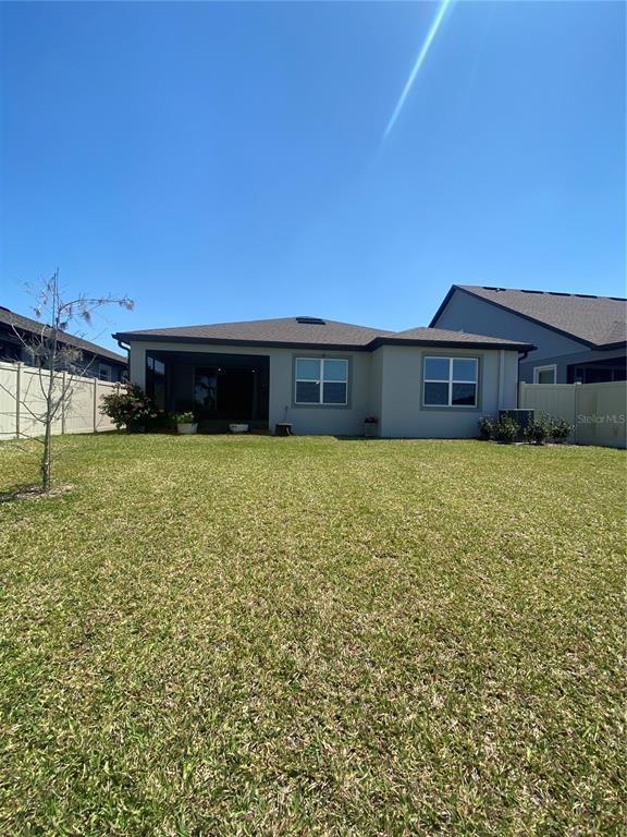 9610 Rally Spring Loop Wesley Chapel, FL 33545 - Photo 26 of 38 a view of a house with a yard