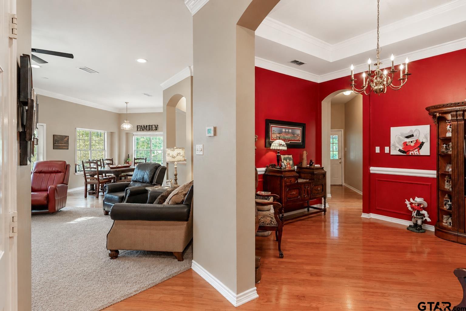 1388 Santa Fe Trail Tyler, TX 75703 - Photo 15 of 46 a living room with furniture a chandelier and a dining table