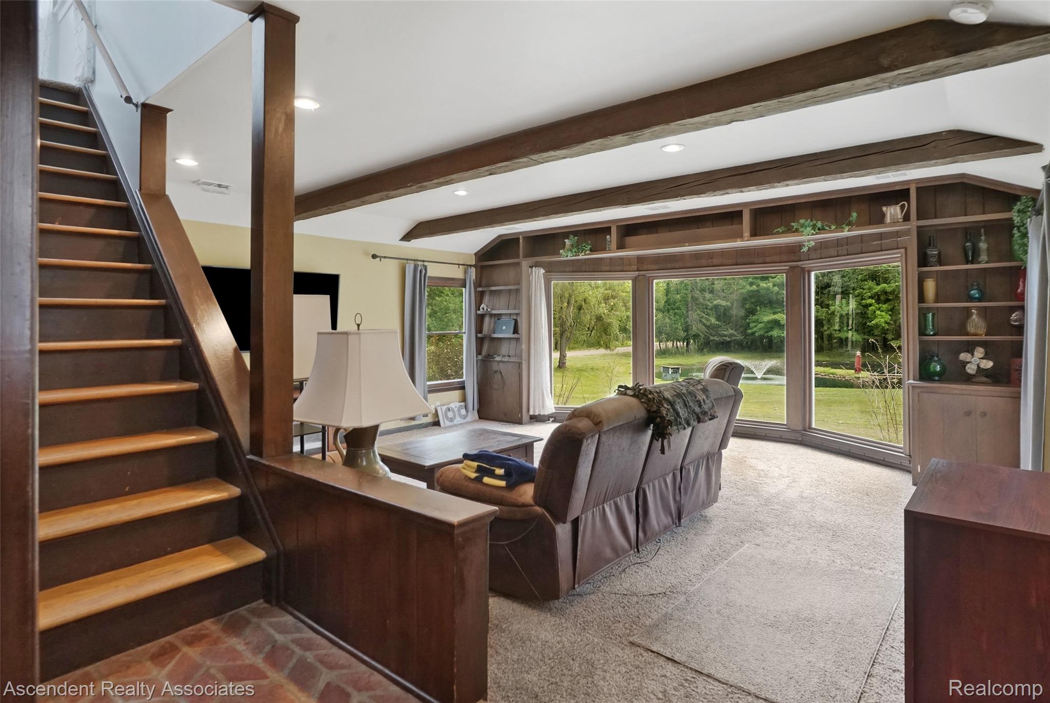6157 Blue Beech Court Rochester, MI 48306 - Photo 11 of 30 Exposed wood beams and recessed lighting. Great views of pond and large back yard. Stairway to 2nd level shown.