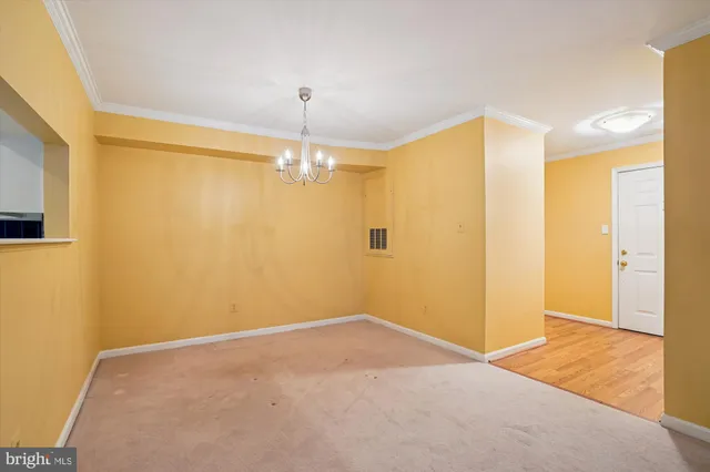 a view of a big room with wooden floor and chandelier