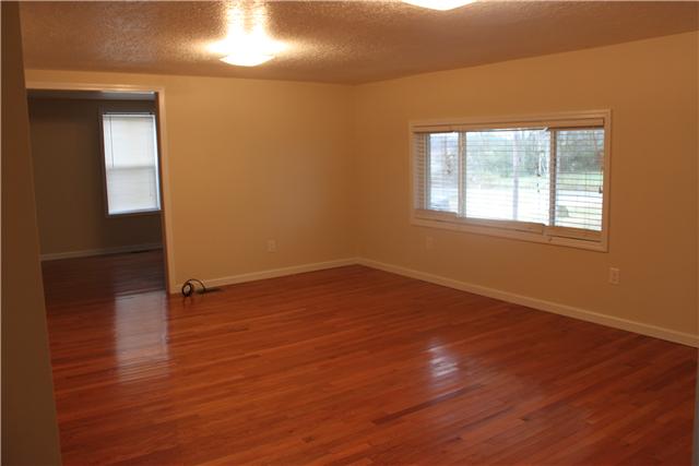 1202 Rutledge Ford Road Decherd, TN 37324 - Photo 2 of 11 an empty room with wooden floor and windows