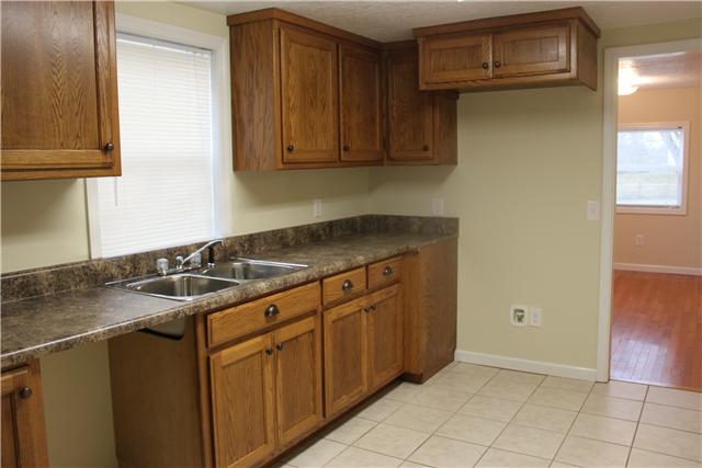 1202 Rutledge Ford Road Decherd, TN 37324 - Photo 3 of 11 a kitchen with granite countertop a sink and a stove