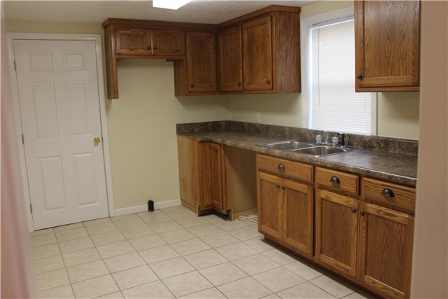 1202 Rutledge Ford Road Decherd, TN 37324 - Photo 4 of 11 a kitchen with stainless steel appliances granite countertop a sink stove and cabinets