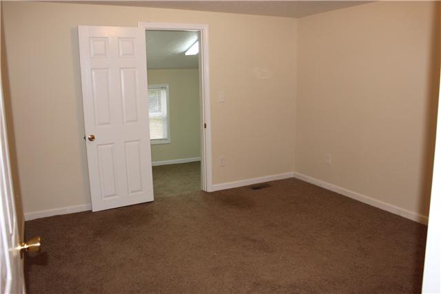 1202 Rutledge Ford Road Decherd, TN 37324 - Photo 6 of 11 an empty room with an empty space and wooden floor