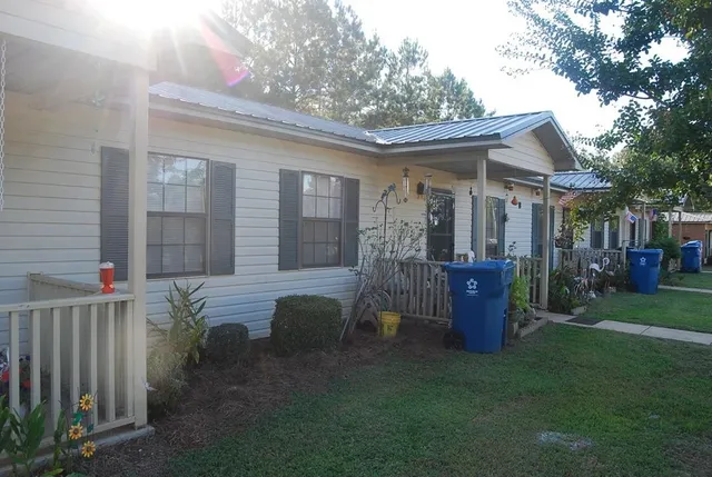 a view of a house with backyard and porch