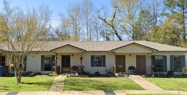 a front view of a house with yard and porch