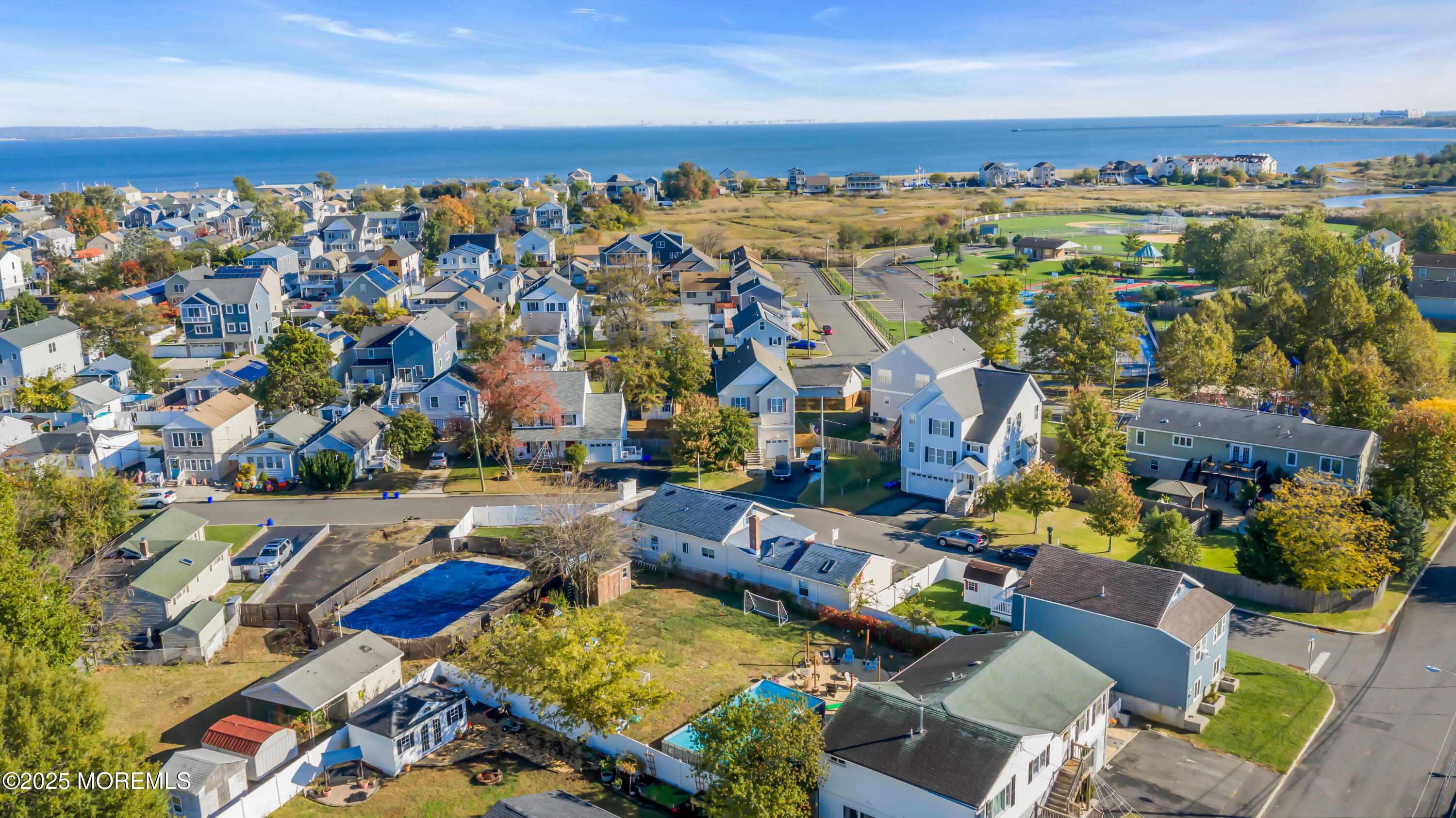 934 7th Street Union Beach, NJ 07735 - Photo 12 of 50 an aerial view of a city with lots of residential buildings and ocean view in back