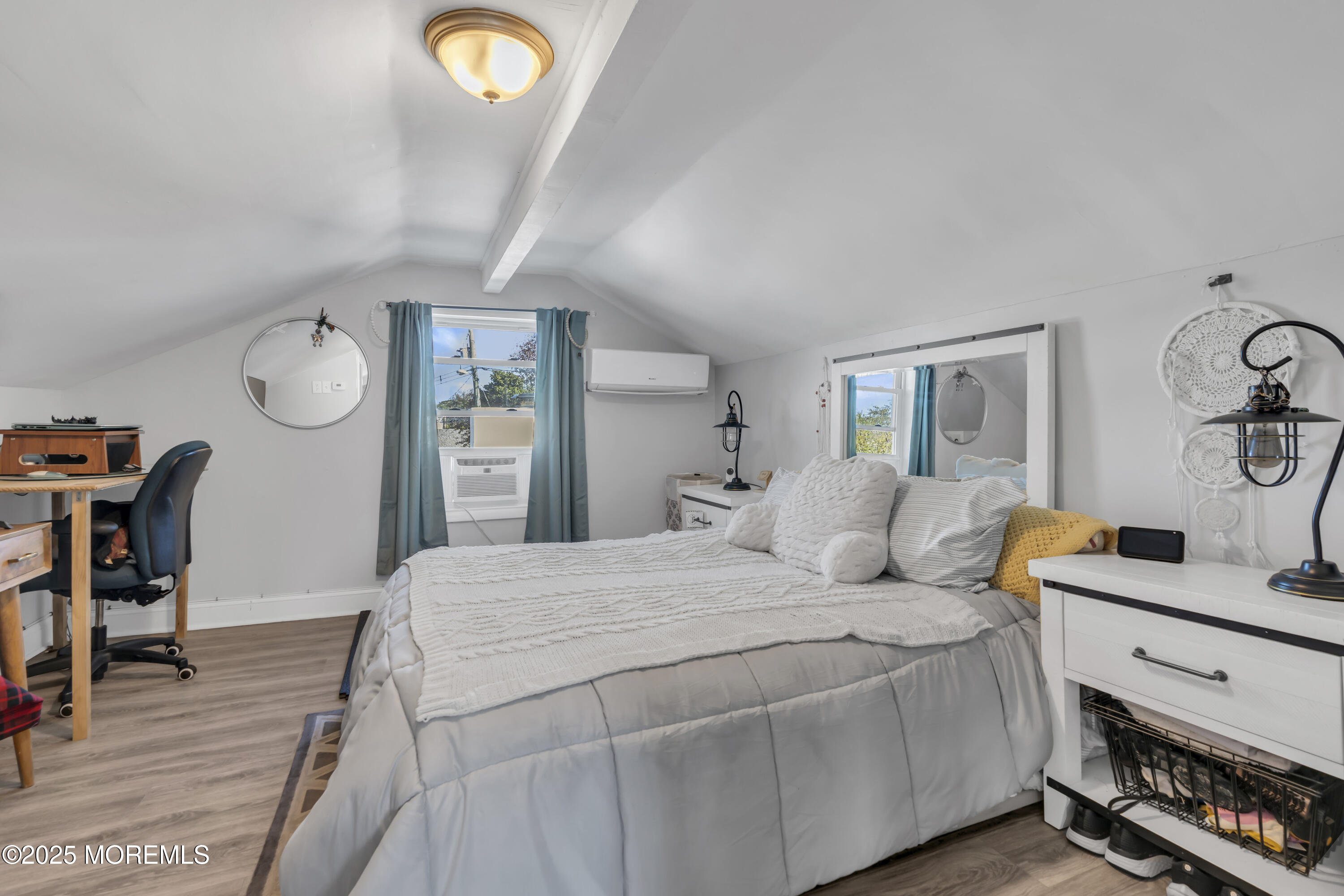 934 7th Street Union Beach, NJ 07735 - Photo 18 of 50 a bedroom with a bed and a table with wooden floor
