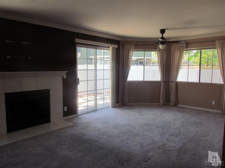 1818 Rory Lane, Unit 2 Simi Valley, CA 93063 - Photo 2 of 13 an empty room with windows and fireplace