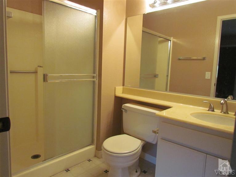 1818 Rory Lane, Unit 2 Simi Valley, CA 93063 - Photo 9 of 13 a bathroom with a granite countertop sink toilet and shower