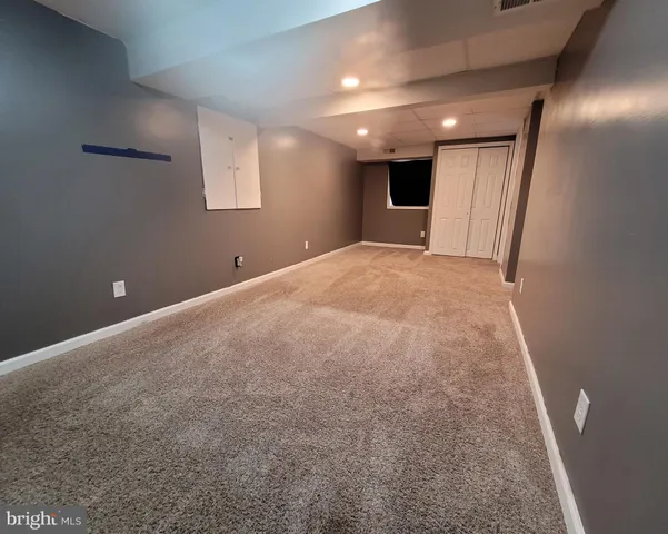 a view of a livingroom with wooden floor and window