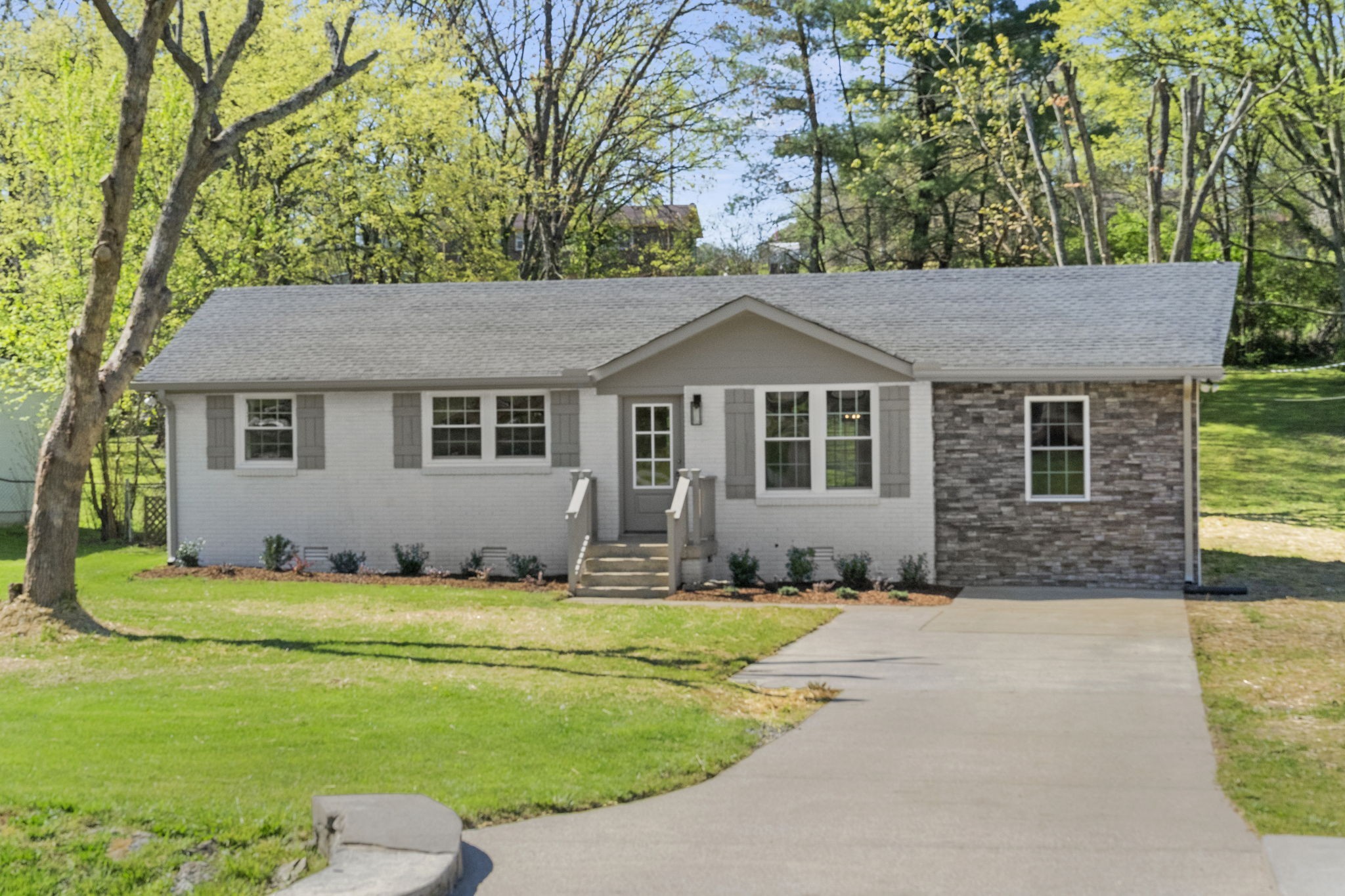a front view of a house with a garden