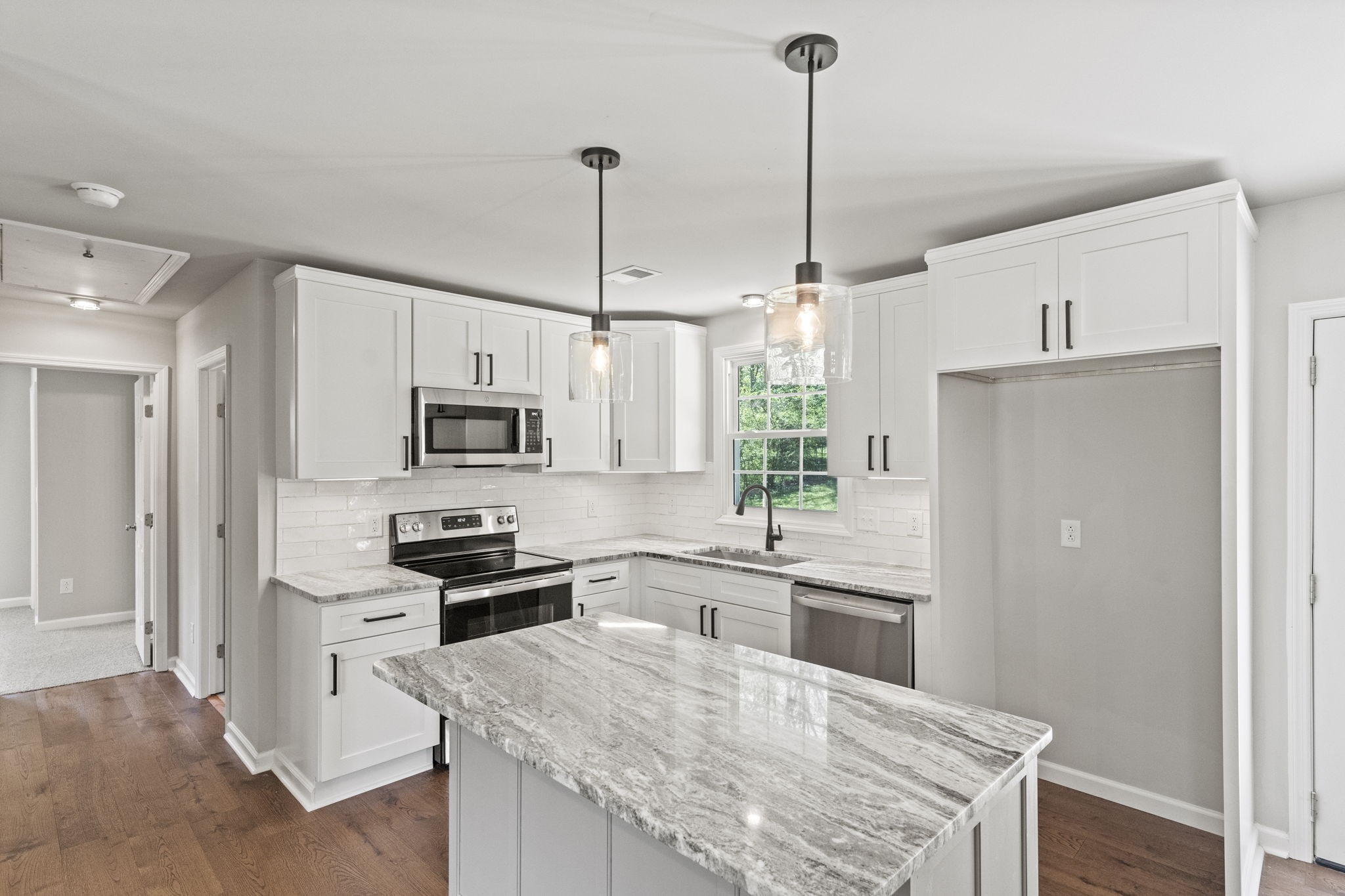 128 South Valley Road Hendersonville, TN 37075 - Photo 13 of 30 a kitchen with white cabinets and stainless steel appliances