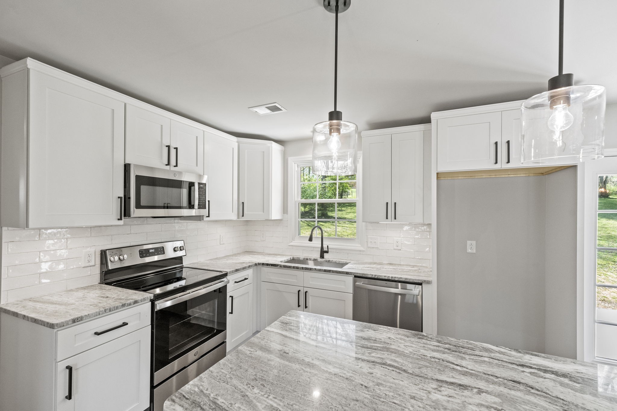 128 South Valley Road Hendersonville, TN 37075 - Photo 14 of 30 a kitchen with stainless steel appliances granite countertop a sink a stove a refrigerator and cabinets