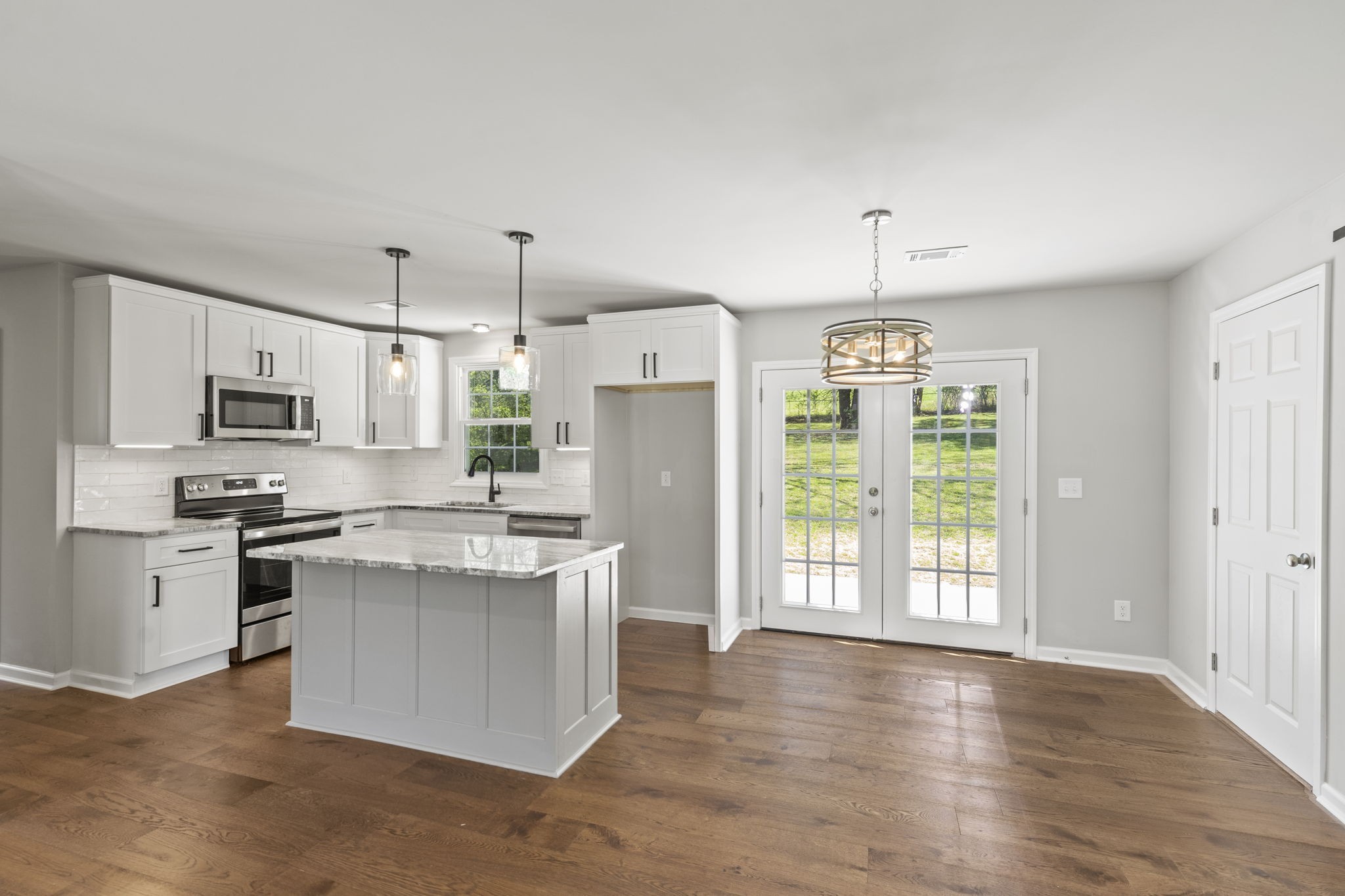 128 South Valley Road Hendersonville, TN 37075 - Photo 10 of 30 a kitchen with stainless steel appliances granite countertop a stove a refrigerator a sink dishwasher and white cabinets with wooden floor