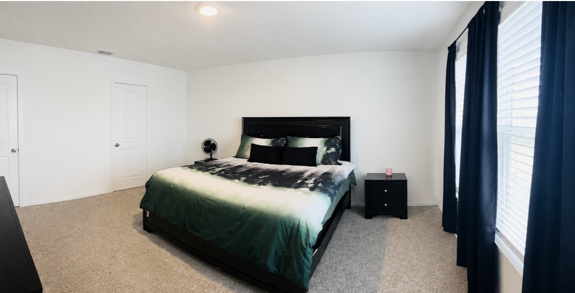14817 Perlino Way, Unit A Manor, TX 78653 - Photo 17 of 40 a bedroom with a bed lamp and a fireplace