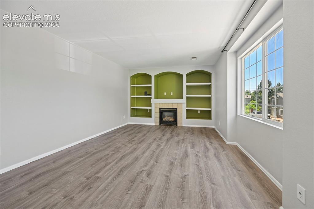 431 Kitfield View Colorado Springs, CO 80916 - Photo 8 of 27 wooden floor in an empty room with a window