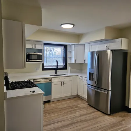 a kitchen with stainless steel appliances a refrigerator stove and sink