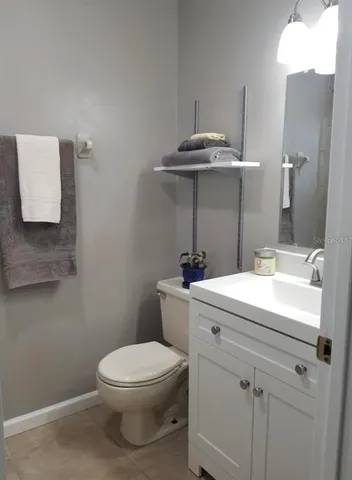 a bathroom with a sink a toilet and shower curtain