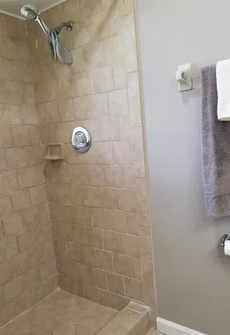 a bathroom with a granite countertop toilet and a sink
