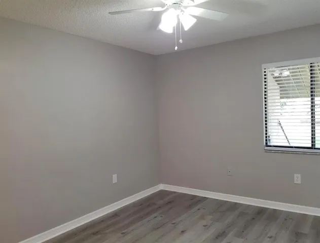 a view of a small space with wooden floor and a window
