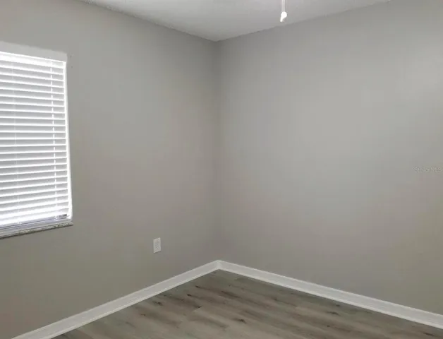 a view of a backyard with table and chairs
